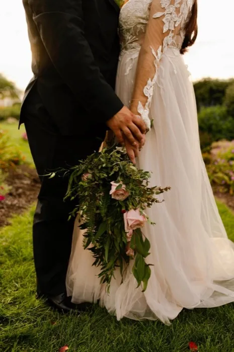 Bride and groom holding hands during their wedding ceremony