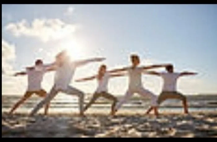 Group practicing qigong movements outdoors